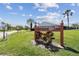Fairway Villas 55+ Senior Community sign amid green grass and palm trees at 8130 Braddock Cir # 3, Port Richey, FL 34668