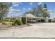 Exterior shot of the home showing the carport and landscaping at 8130 Braddock Cir # 3, Port Richey, FL 34668