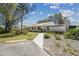 Exterior shot of the home with landscaping and a sidewalk at 8130 Braddock Cir # 3, Port Richey, FL 34668