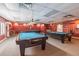 The game room features three pool tables with lighting and equipment at 8130 Braddock Cir # 3, Port Richey, FL 34668