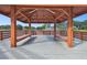 Interior view of a community wooden gazebo with benches overlooking a picturesque lake at 8130 Braddock Cir # 3, Port Richey, FL 34668