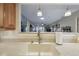 Bright kitchen sink featuring a white granite counter and view into the living room at 8130 Braddock Cir # 3, Port Richey, FL 34668