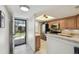 Bright kitchen view with a view of the entry and outdoor access at 8130 Braddock Cir # 3, Port Richey, FL 34668
