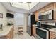 Kitchen featuring stainless steel appliances, wood cabinets, and light colored granite counters at 8130 Braddock Cir # 3, Port Richey, FL 34668