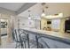 Breakfast bar and kitchen with pendant lighting, seamlessly connecting spaces in this inviting home at 8130 Braddock Cir # 3, Port Richey, FL 34668
