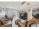 Comfortable living room with tile flooring, leather furniture, and sliding glass doors to a patio at 8130 Braddock Cir # 3, Port Richey, FL 34668