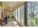 Enclosed patio with vertical blinds offering ample light and views of the outdoors at 8130 Braddock Cir # 3, Port Richey, FL 34668