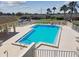 Beautiful community pool with lounge chairs and tables to enjoy the outdoors at 8130 Braddock Cir # 3, Port Richey, FL 34668