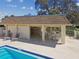 Community pool with shaded lounge area equipped with a small kitchen and tables at 8130 Braddock Cir # 3, Port Richey, FL 34668
