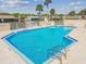 Beautiful community pool with lounge chairs and tables to enjoy the outdoors at 8130 Braddock Cir # 3, Port Richey, FL 34668