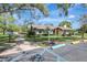 Inviting clubhouse with landscaped grounds and accessible parking, ideal for gatherings and community events at 864 Pinewood W Ter, Palm Harbor, FL 34683