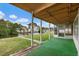 Relaxing covered back porch and outdoor living space with water views overlooking lush green yard at 9101 Oak Ne St, St Petersburg, FL 33702