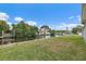 Lush backyard leading to the water with a dock, perfect for outdoor entertaining and enjoying waterfront living at 9101 Oak Ne St, St Petersburg, FL 33702