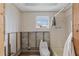 Bathroom displaying renovation with visible studs and block walls, as well as toilet and shower at 9101 Oak Ne St, St Petersburg, FL 33702
