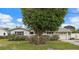 Charming single-story home with mature landscaping, a well-manicured lawn and attached garage at 9101 Oak Ne St, St Petersburg, FL 33702