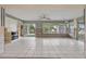 Sunlit living room with tiled floor, canal view, and exposed interior wall structure at 9101 Oak Ne St, St Petersburg, FL 33702