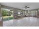 Spacious living room with sliding doors leading to canal side yard and exposed block walls at 9101 Oak Ne St, St Petersburg, FL 33702