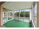 Bright, enclosed porch overlooking a canal with a view of other homes and lush greenery at 9101 Oak Ne St, St Petersburg, FL 33702