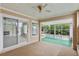 Enclosed porch with canal views, ceiling fan, and sliding glass door, revealing renovation at 9101 Oak Ne St, St Petersburg, FL 33702