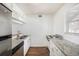Efficient kitchen featuring stainless steel appliances, granite countertops, and white cabinetry at 10453 Carrollbrook Cir # 122, Tampa, FL 33618