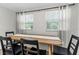 Bright dining area with a light wood table, modern black chairs, and window views at 1076 Philippe Pkwy, Safety Harbor, FL 34695