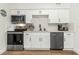 Bright kitchen features stainless steel appliances, white cabinetry and quartz countertops at 1076 Philippe Pkwy, Safety Harbor, FL 34695