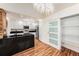 Modern kitchen boasts stainless steel appliances, black granite countertops, white cabinetry, and a stylish chandelier at 13518 Palmwood Ln # 13518, Tampa, FL 33618