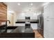 Modern kitchen with stainless steel appliances, granite countertops, and stylish white cabinets at 13518 Palmwood Ln # 13518, Tampa, FL 33618