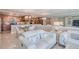 Open-concept living room and kitchen area with modern furnishings and a mirrored wall feature at 1460 Gulf Blvd # 1002, Clearwater Beach, FL 33767