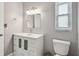 This bathroom features a single sink vanity with a modern faucet and framed mirror at 1820 Greenhill Dr, Clearwater, FL 33755