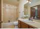 Functional bathroom featuring a vanity, sink, mirror and a combined shower and tub at 1888 Springbush Ln, Clearwater, FL 33763