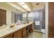 Bathroom showcasing a spacious vanity, a large mirror, and a glass-enclosed shower at 1888 Springbush Ln, Clearwater, FL 33763
