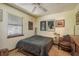 Comfortable bedroom with natural light, a ceiling fan, and a cozy seating area at 1888 Springbush Ln, Clearwater, FL 33763