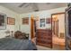 Comfortable bedroom featuring a ceiling fan, dresser and a doorway leading to the rest of the home at 1888 Springbush Ln, Clearwater, FL 33763