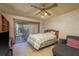 Bedroom with a ceiling fan, sliding glass doors leading to a patio, and comfortable seating at 1888 Springbush Ln, Clearwater, FL 33763