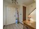 Bright entryway featuring tiled flooring, a wooden table and a door to the outside at 1888 Springbush Ln, Clearwater, FL 33763