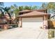Home featuring a wide driveway, neutral brick accents, a two-car garage, and meticulous landscaping at 1888 Springbush Ln, Clearwater, FL 33763