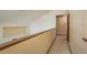 Upstairs hallway with carpet and a partial wall overlooking the lower level at 1888 Springbush Ln, Clearwater, FL 33763