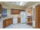 Bright kitchen with white appliances, ample counter space, and an adjacent dining area at 1888 Springbush Ln, Clearwater, FL 33763