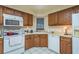 Well-organized kitchen with ample counter space, wood cabinets, and a dishwasher at 1888 Springbush Ln, Clearwater, FL 33763