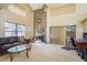 Bright living room features a brick fireplace, high ceilings, and sliding glass doors to the backyard at 1888 Springbush Ln, Clearwater, FL 33763
