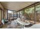 Enclosed patio area with outdoor seating, a table and partial views of the surrounding area at 1888 Springbush Ln, Clearwater, FL 33763