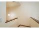 Well-lit stairwell with a wooden handrail leading to the upper level of the home at 1888 Springbush Ln, Clearwater, FL 33763
