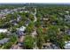 Aerial view with a red arrow indicating the property's location in a leafy residential neighborhood, cityscape in the background at 203 S Coolidge Ave, Tampa, FL 33609