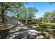 Charming single-story home with a detached garage, screened in patio, and a well-maintained front yard at 203 S Coolidge Ave, Tampa, FL 33609