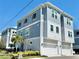 Stylish three-story townhome featuring a two-car garage, and modern architectural details at 208 S Tampania Ave # 4, Tampa, FL 33609