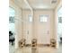 Bright hallway with mirror sliding closet doors and a view of the front door at 208 S Tampania Ave # 4, Tampa, FL 33609