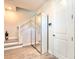 Bright hallway features staircase, a storage closet with mirrored doors, and access to front door at 208 S Tampania Ave # 4, Tampa, FL 33609