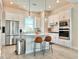 Bright kitchen featuring white cabinetry, stainless steel appliances, and a center island with seating at 208 S Tampania Ave # 4, Tampa, FL 33609