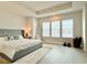 Serene main bedroom with large windows, tray ceilings, modern furniture, and wood-look flooring at 208 S Tampania Ave # 4, Tampa, FL 33609